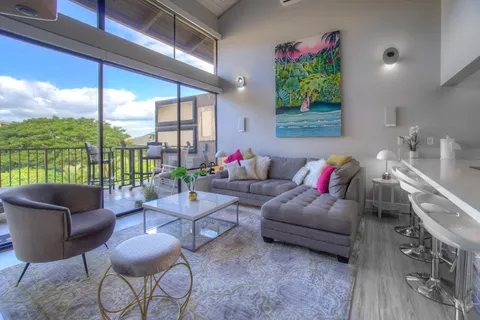 a living room with furniture and a potted plant