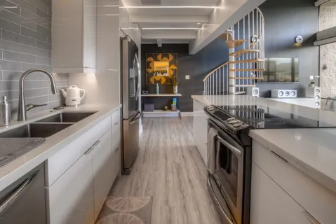 a kitchen with stainless steel appliances granite countertop a stove and a sink