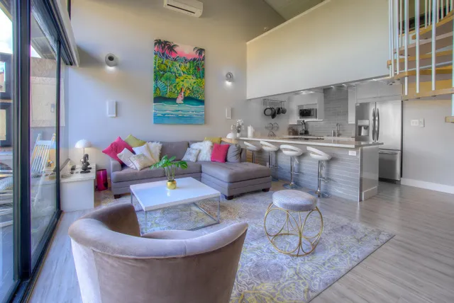 a living room with furniture and a floor to ceiling window