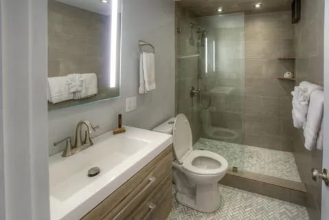 a bathroom with a sink toilet and shower