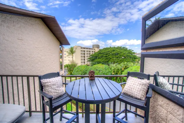 a view of a patio with table and chairs with wooden floor and fence