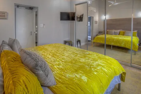 a bed sitting in a bedroom and a table