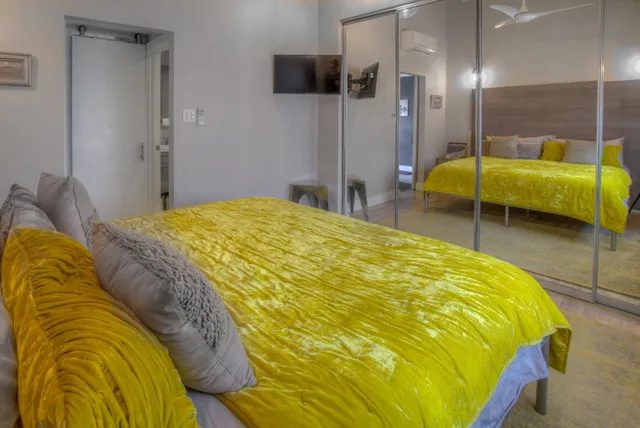 a bed sitting in a bedroom and a table