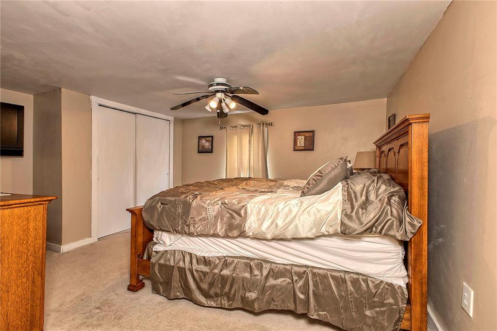 8002 Hayward Street Irwin, PA 15642 - Photo 18 of 31 a bedroom with a bed and a chandelier