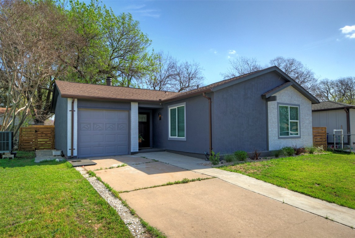 2510 Dovemeadow Drive Austin, TX 78744 - Photo 1 of 1 a front view of a house with a yard and garage