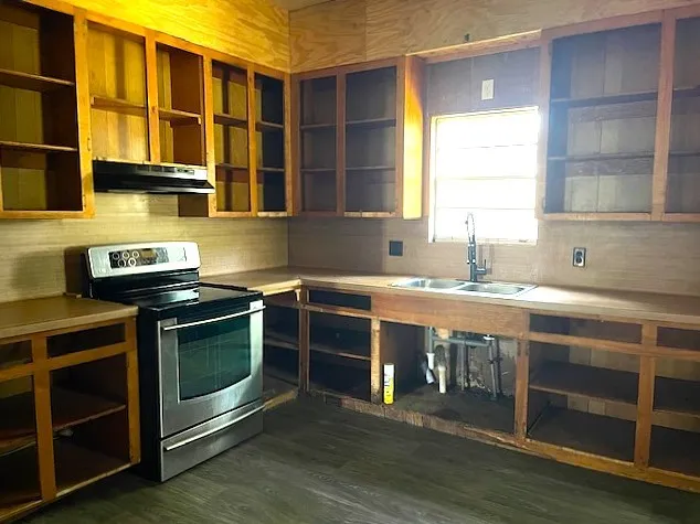 a kitchen with stainless steel appliances granite countertop a stove and a sink