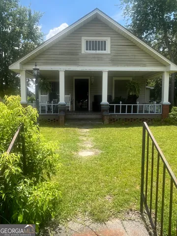 a view of a house with swimming pool and porch with furniture