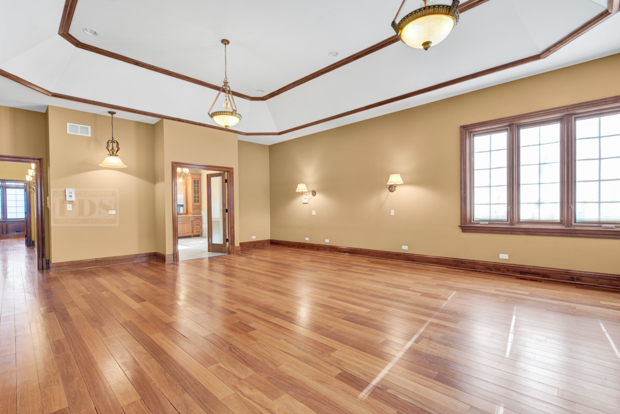 38W340 Henricksen Road St. Charles, IL 60175 - Photo 12 of 54 a view of an empty room with window and wooden floor