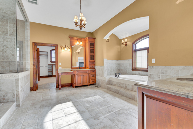 38W340 Henricksen Road St. Charles, IL 60175 - Photo 13 of 54 a spacious bathroom with a granite countertop tub sink and mirror