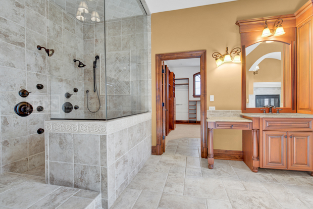 38W340 Henricksen Road St. Charles, IL 60175 - Photo 14 of 54 a bathroom with a tub a sink and a mirror