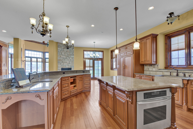 38W340 Henricksen Road St. Charles, IL 60175 - Photo 21 of 54 a kitchen with a stove a sink a center island and windows