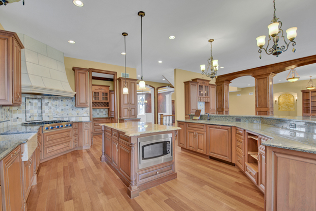 38W340 Henricksen Road St. Charles, IL 60175 - Photo 22 of 54 a large kitchen with stainless steel appliances granite countertop a stove and a wooden floors