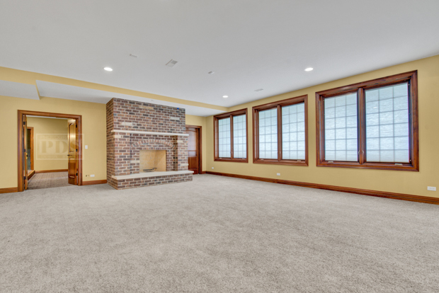 38W340 Henricksen Road St. Charles, IL 60175 - Photo 46 of 54 a view of an empty room with a fireplace and a large window