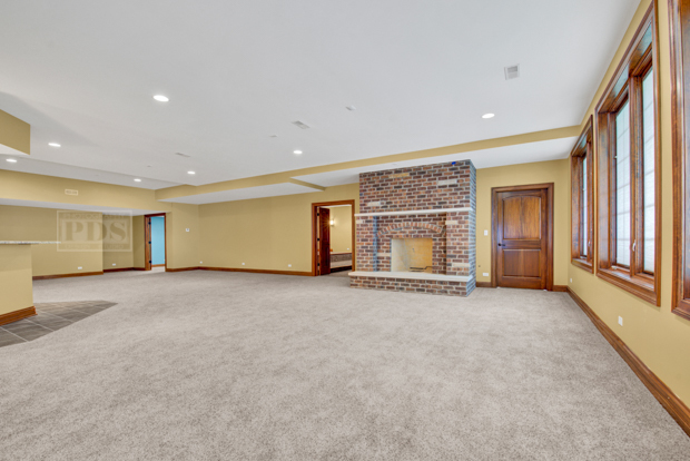 38W340 Henricksen Road St. Charles, IL 60175 - Photo 47 of 54 a view of an empty room with a fireplace and a window