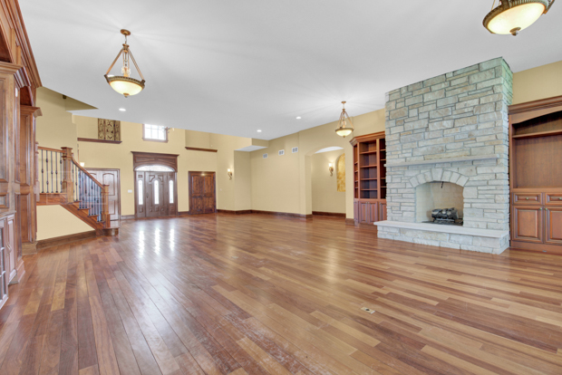 38W340 Henricksen Road St. Charles, IL 60175 - Photo 9 of 54 a view of a livingroom with wooden floor and a fireplace