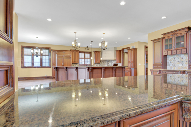 38W340 Henricksen Road St. Charles, IL 60175 - Photo 10 of 54 an open kitchen with kitchen island a sink appliances and a counter top space