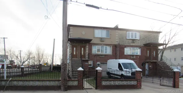 a view of a building with cars parked