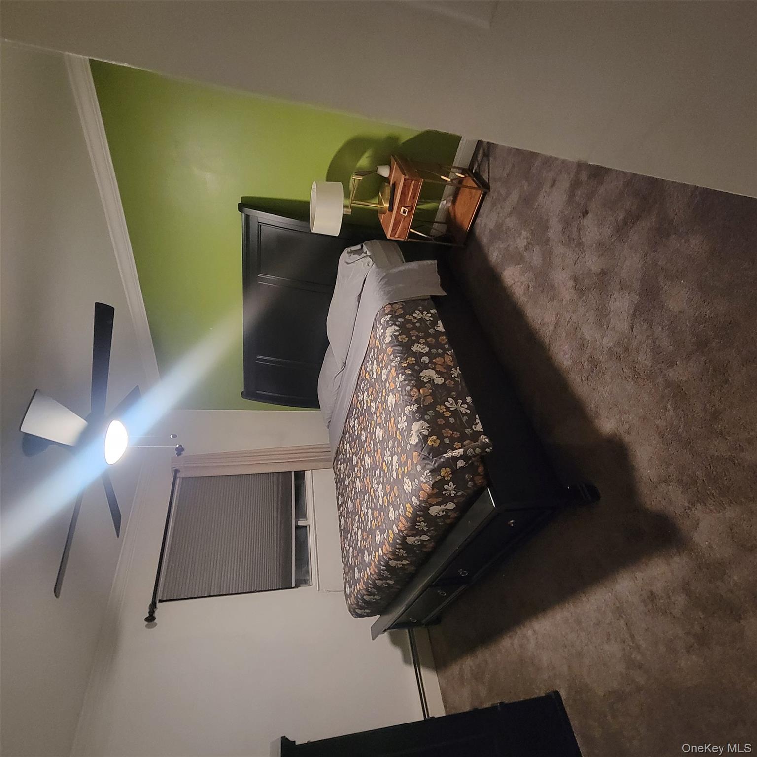 236-14 Bentley Road Queens, NY 11422 - Photo 5 of 7 a bed sitting in a room next to a lamp