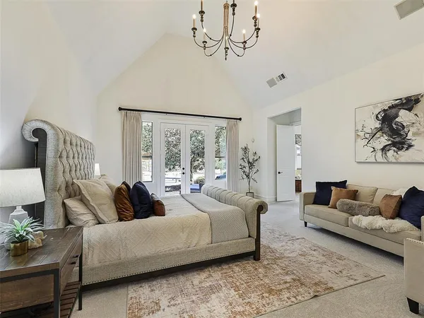 a bedroom with a bed a couch and dresser