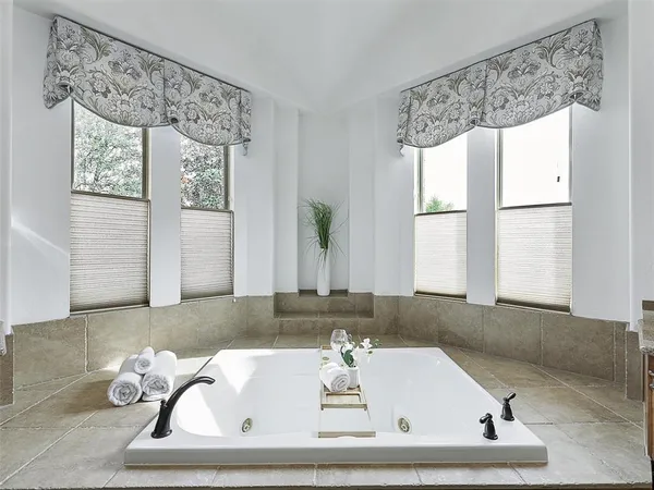 a bathroom with a bathtub sink and window