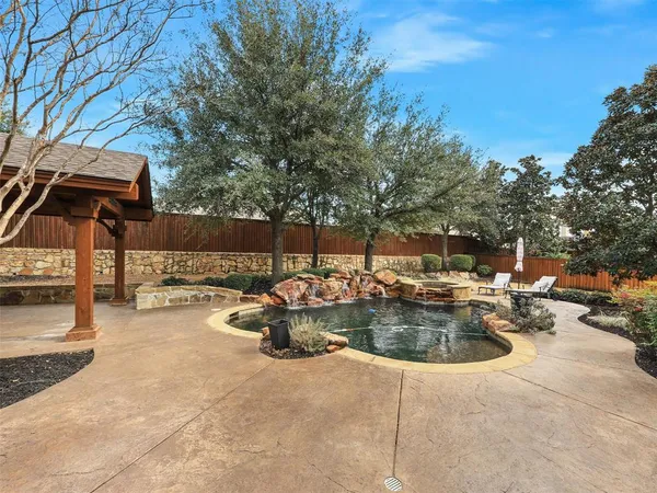 a view of swimming pool with outdoor seating and plants