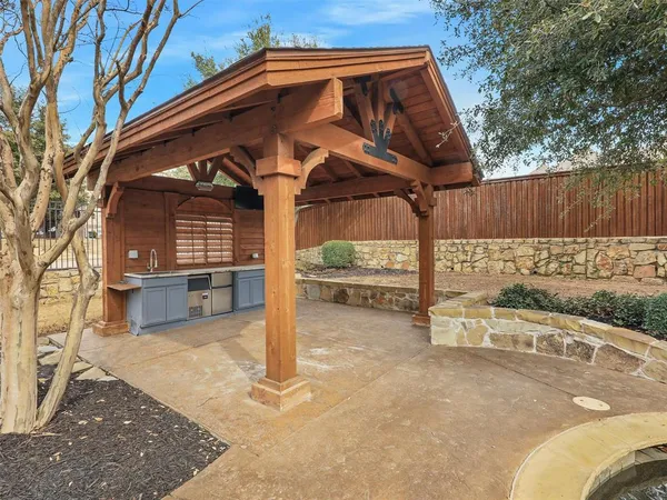 a view of a house with a wooden fence