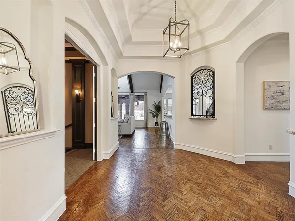 a view of a hallway with entryway wooden floor and front door