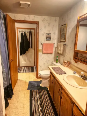 a bathroom with a sink a mirror and a bathtub