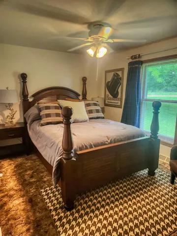 a bedroom with a bed and glass door