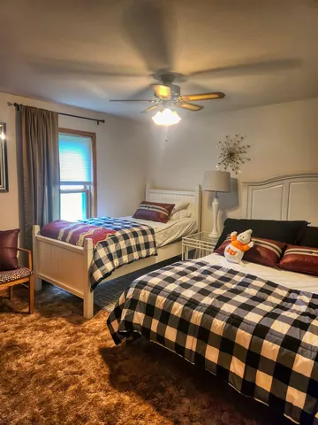 a bedroom with two beds and painting on the wall