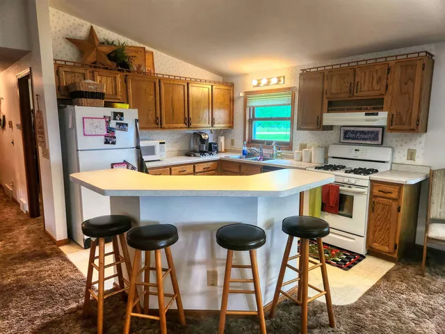 a kitchen with furniture a center island stainless steel appliances and cabinets