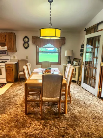 a view of a dining room with furniture and a window