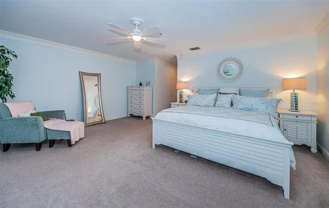 a spacious bedroom with a bed and a chandelier