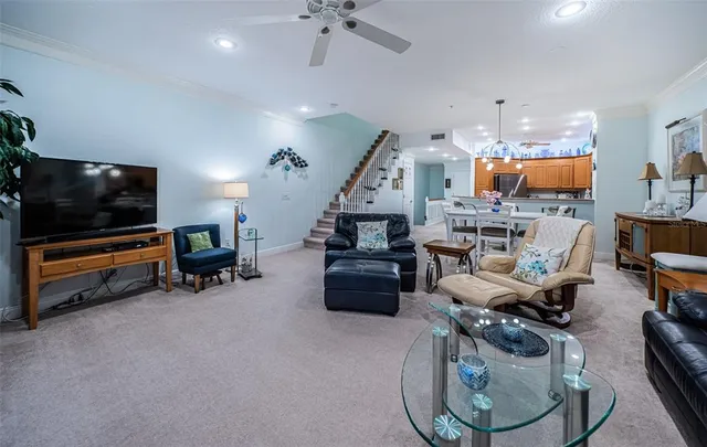 a living room with furniture and a chandelier