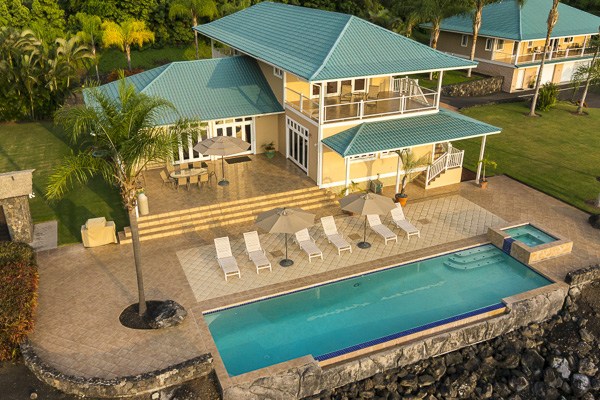 a roof deck with a table and chairs under an umbrella