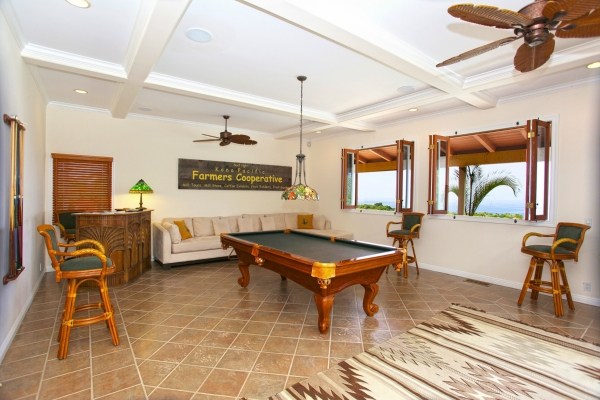 82-5970 Napoopoo Road Captain Cook, HI 96704 - Photo 14 of 24 a living room with furniture a rug and a chandelier