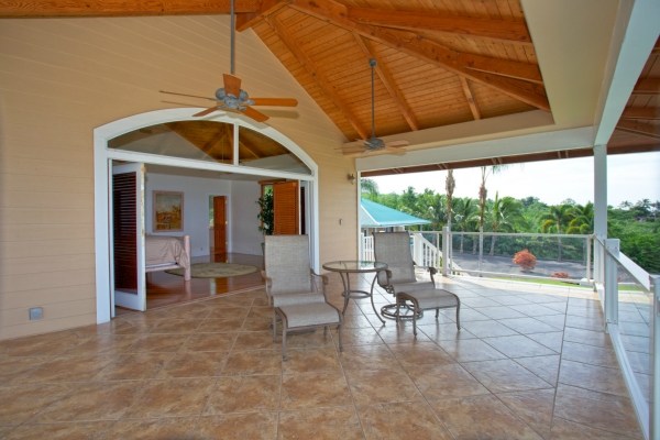 82-5970 Napoopoo Road Captain Cook, HI 96704 - Photo 15 of 24 a view of a patio with table and chairs and potted plants