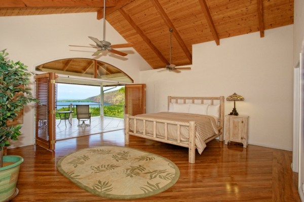 82-5970 Napoopoo Road Captain Cook, HI 96704 - Photo 16 of 24 a bed sitting in a room next to a window