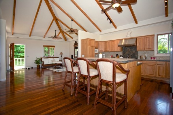 82-5970 Napoopoo Road Captain Cook, HI 96704 - Photo 18 of 24 a kitchen with stainless steel appliances granite countertop a table chairs sink and cabinets