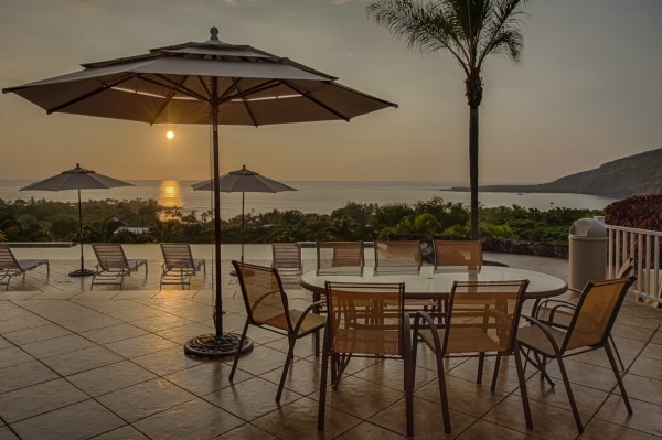 82-5970 Napoopoo Road Captain Cook, HI 96704 - Photo 23 of 24 a view of a terrace with furniture and umbrella