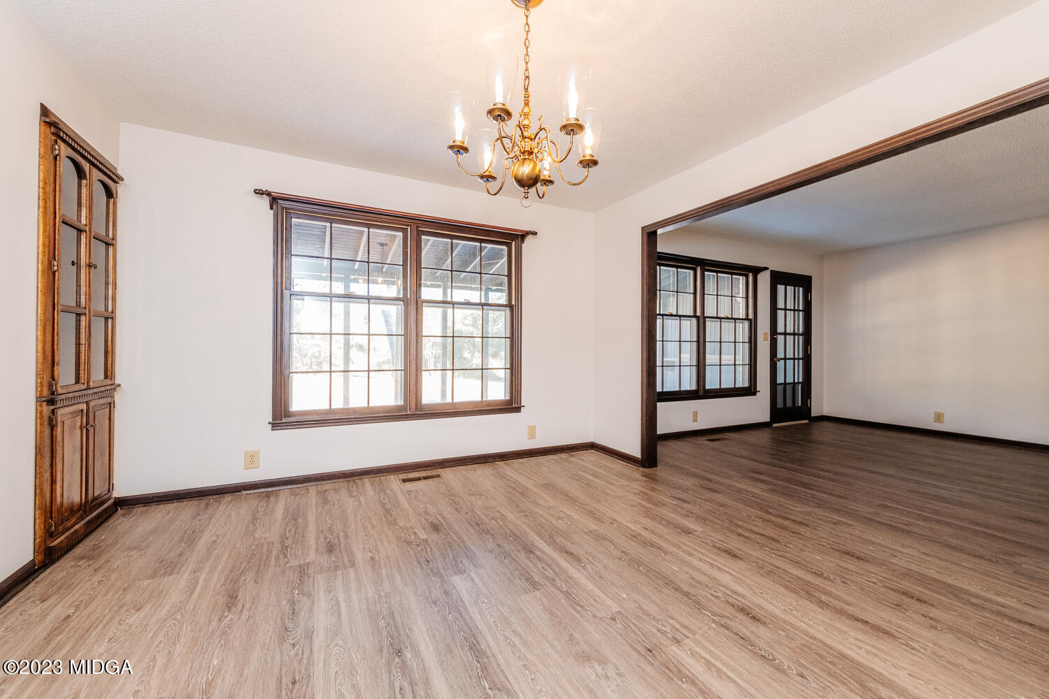 7737 Columbus Road Lizella, GA 31052 - Photo 8 of 47 a view of an empty room with wooden floor and a window