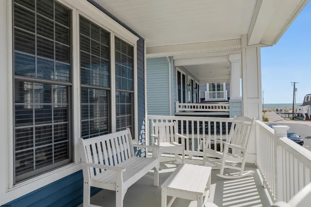 a view of a chair and table on the deck