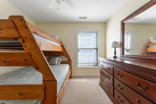 a bedroom with a bed and a desk