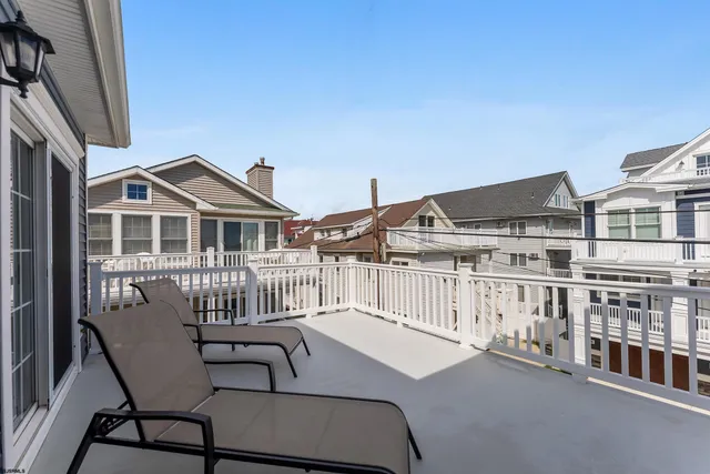 a balcony with table and chairs