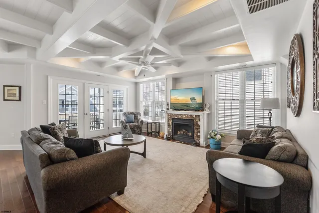 a living room with furniture a fireplace and a large window