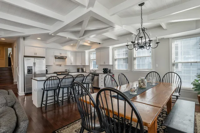 a room with lots of chairs and chandelier