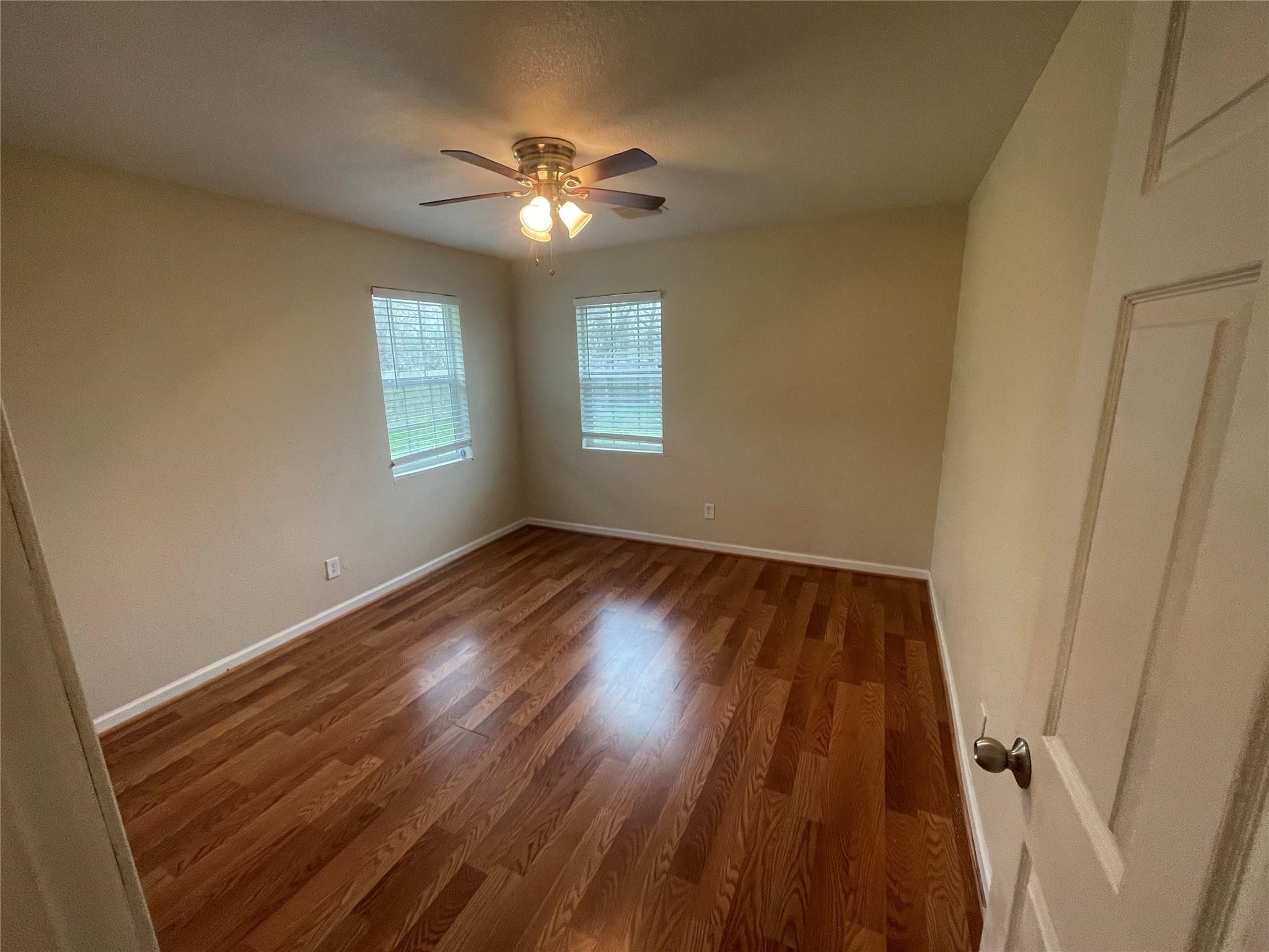 6315 Sayers Street Houston, TX 77026 - Photo 4 of 11 a view of an empty room with wooden floor and a window
