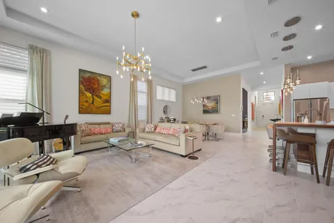 a living room with furniture and a chandelier
