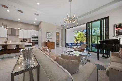 a living room with furniture or kitchen and a chandelier