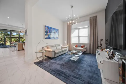 a living room with furniture and a chandelier